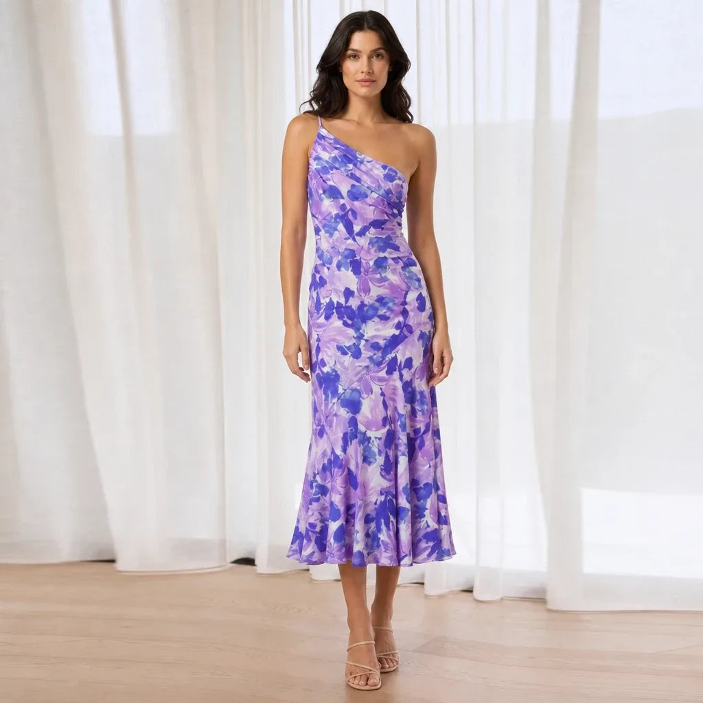 Purple floral one-shoulder midi dress on model in contrapposto stance