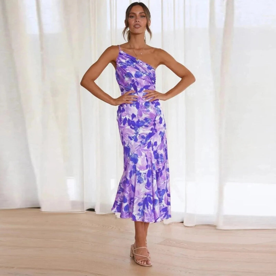 Model wearing a purple floral one-shoulder midi dress