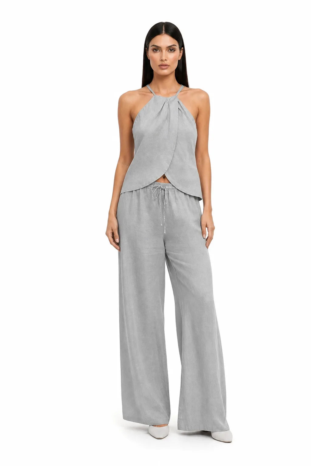 Gray halter wrap crop top and skirt two-piece set on model in contrapposto stance