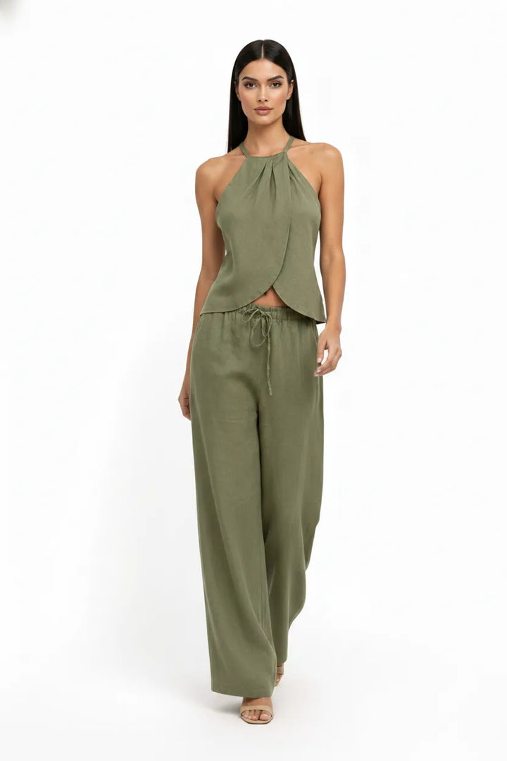 Green halter wrap crop top and skirt two-piece set on model in natural movement