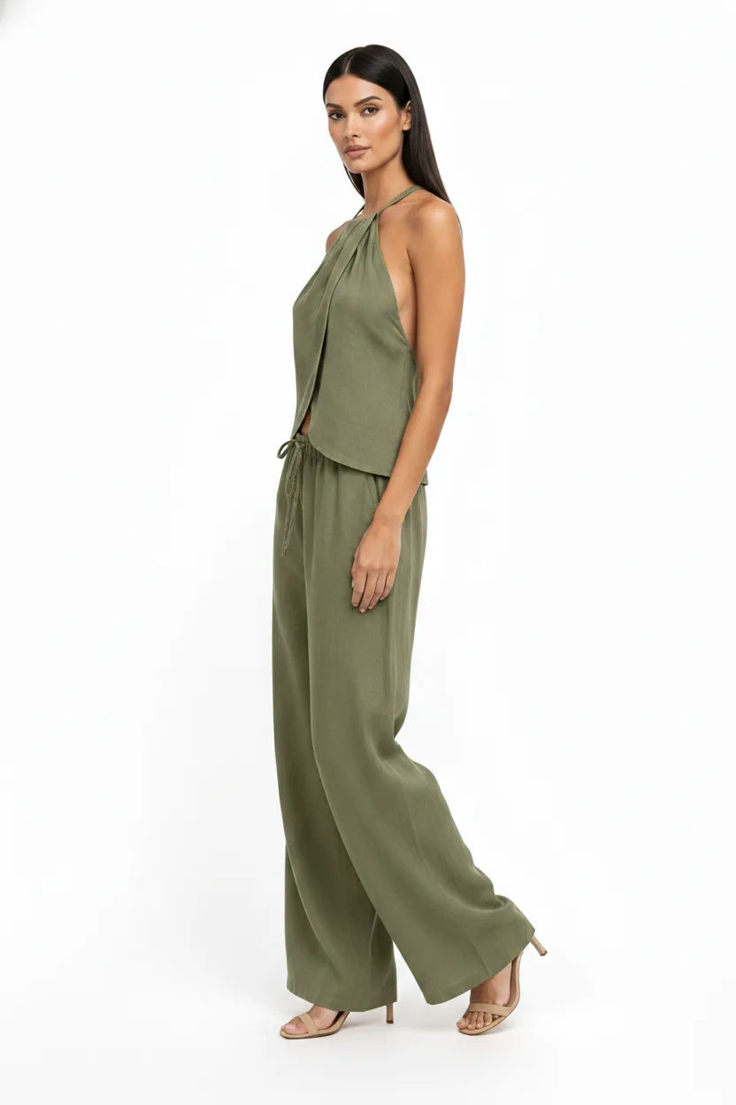 Green halter wrap crop top and skirt two-piece set on model in three-quarter turn