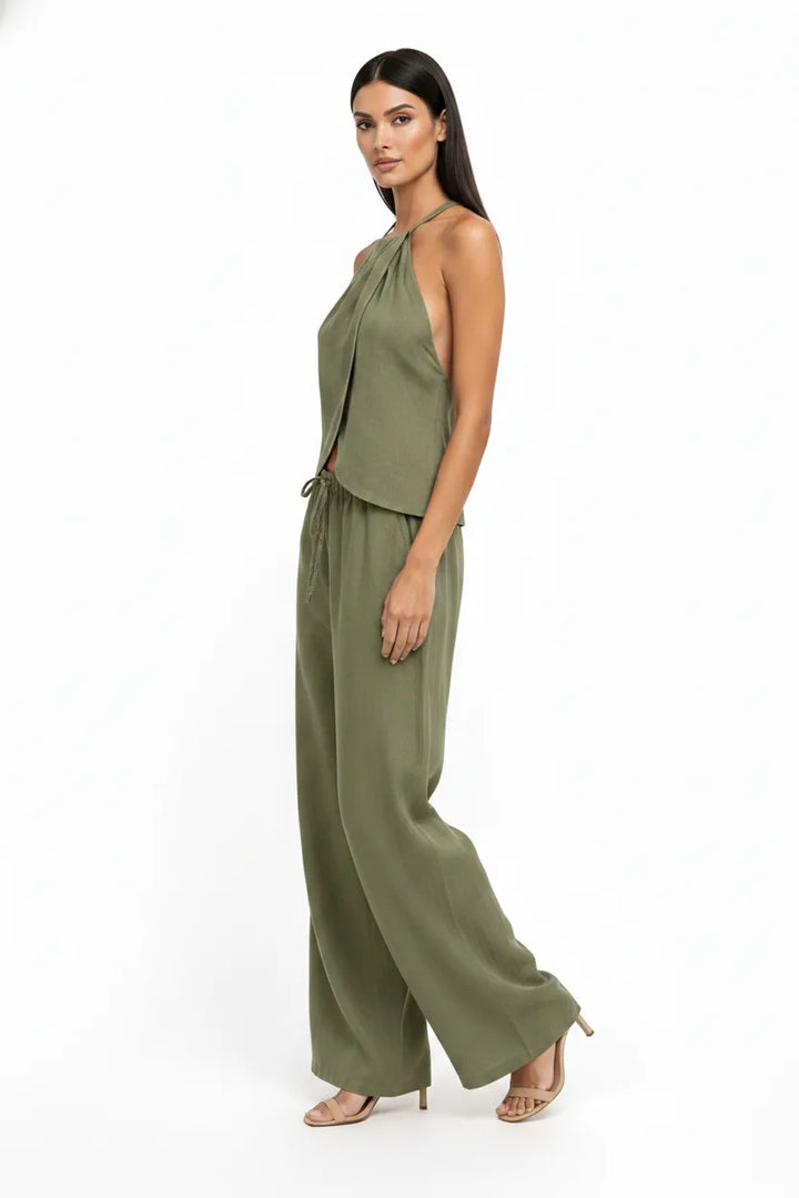 Green halter wrap crop top and skirt two-piece set on model in three-quarter turn