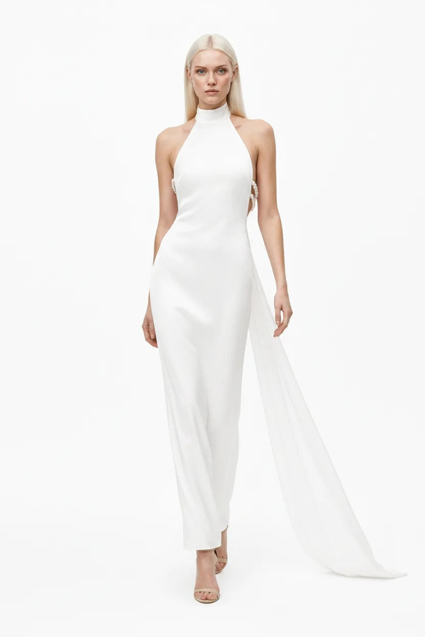 White halter gown with pearl back detail, model in natural movement