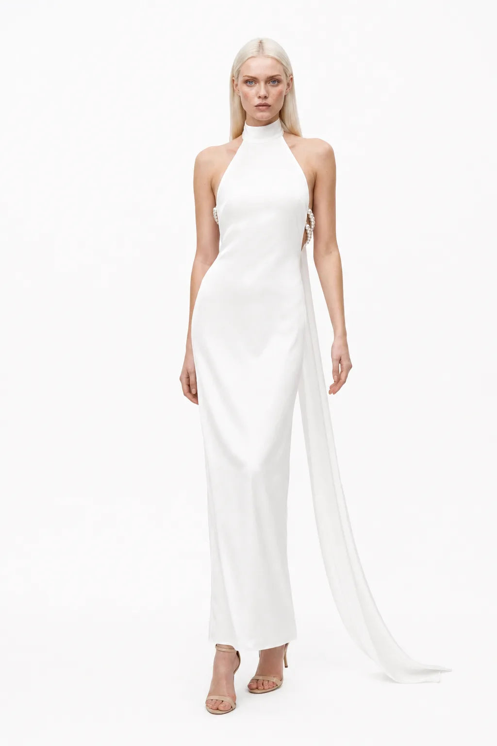 White halter gown with pearl back detail, model in contrapposto stance