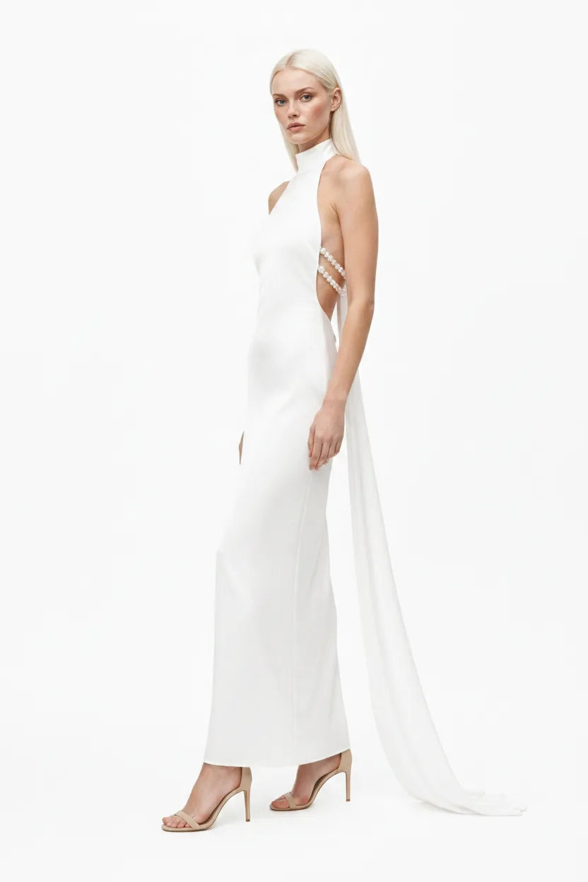 White halter gown with pearl back detail, model in three-quarter turn