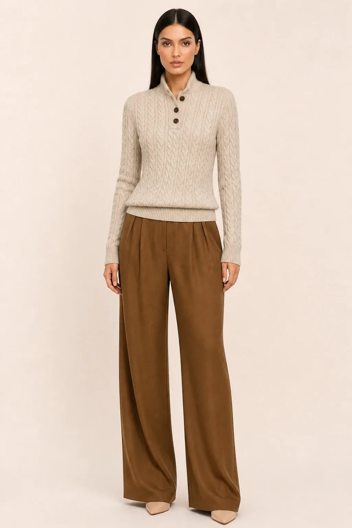 Gray cable knit button-neck sweater on a model in a contrapposto stance