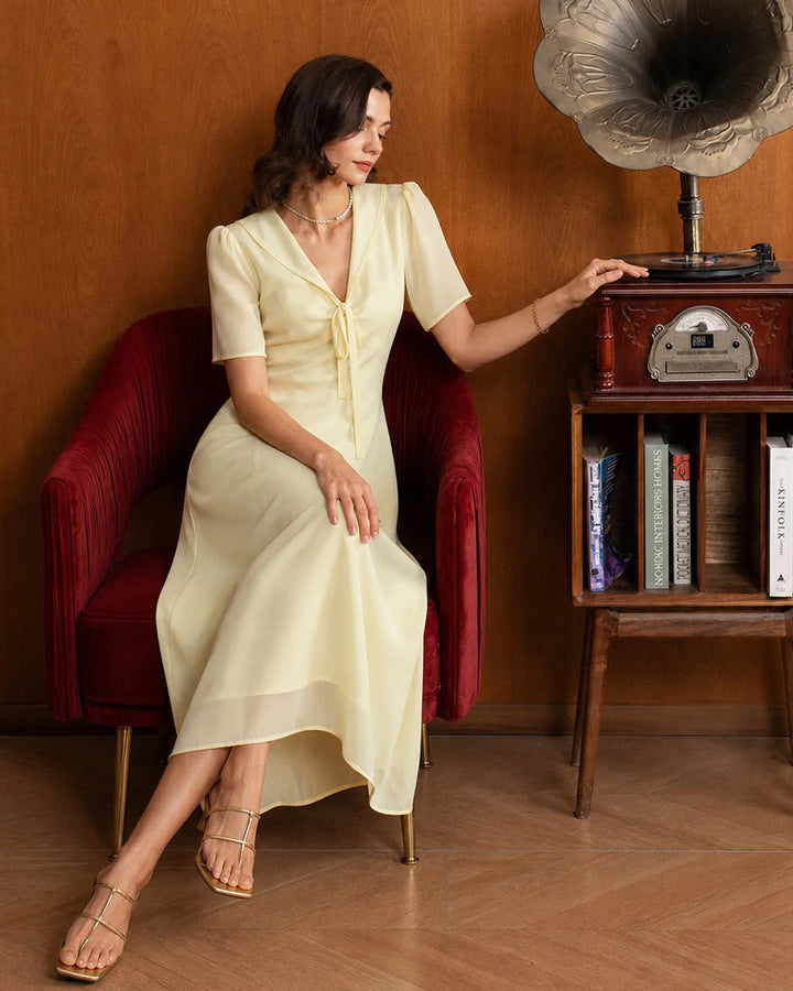 Close-up detail of sailor collar on yellow midi dress