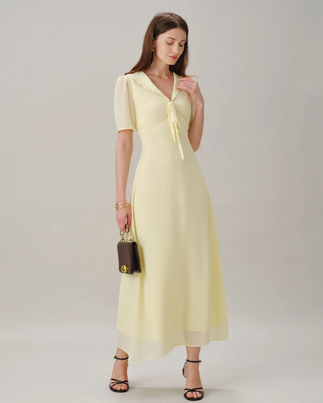 Yellow midi dress with sailor collar, model walking pose