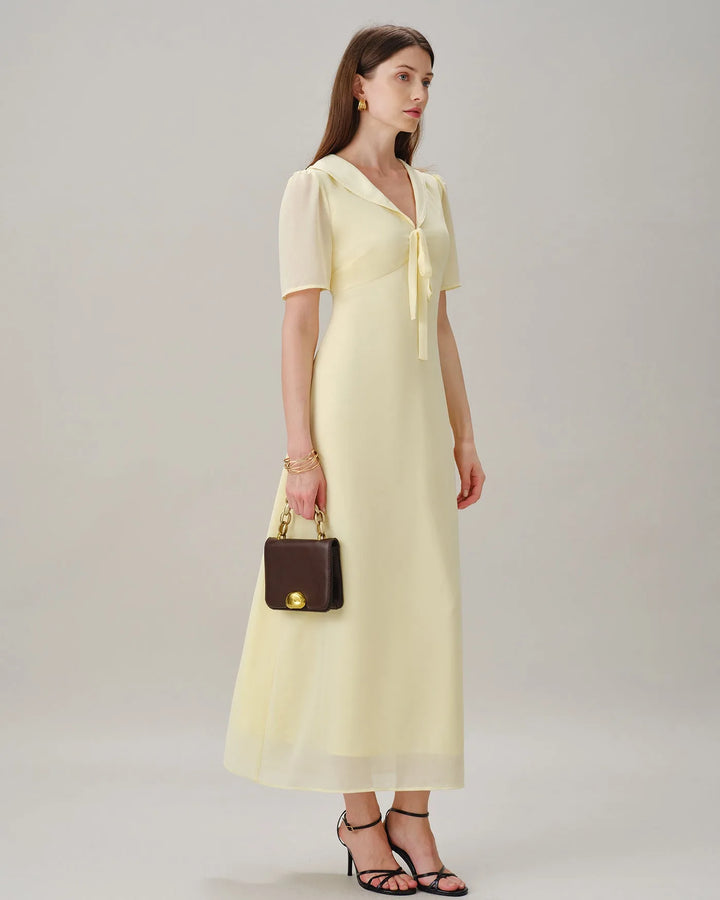 Yellow sailor collar midi dress, model seated or relaxed pose