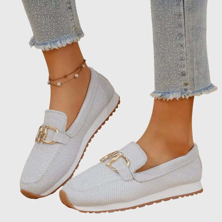 White platform loafer with gold horsebit detail, front view