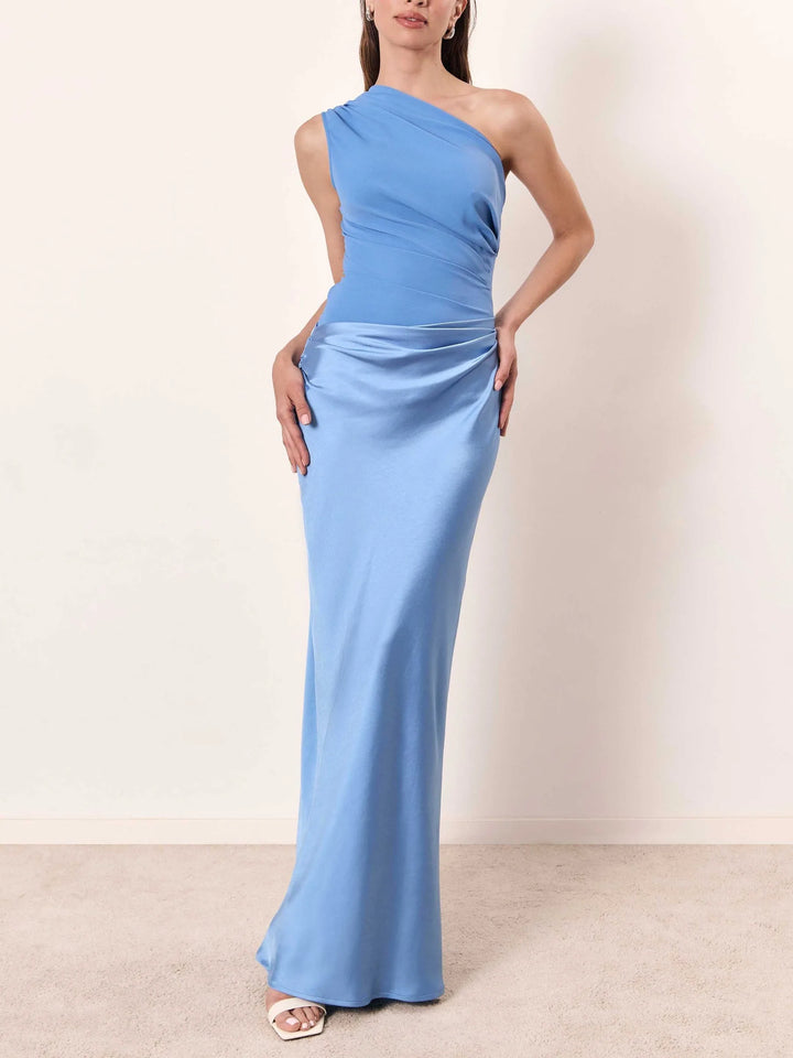 Blue one-shoulder floor-length gown on a model in a side pose