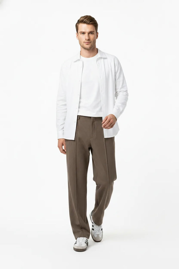 Brown pleated wide-leg trousers on a model in natural movement