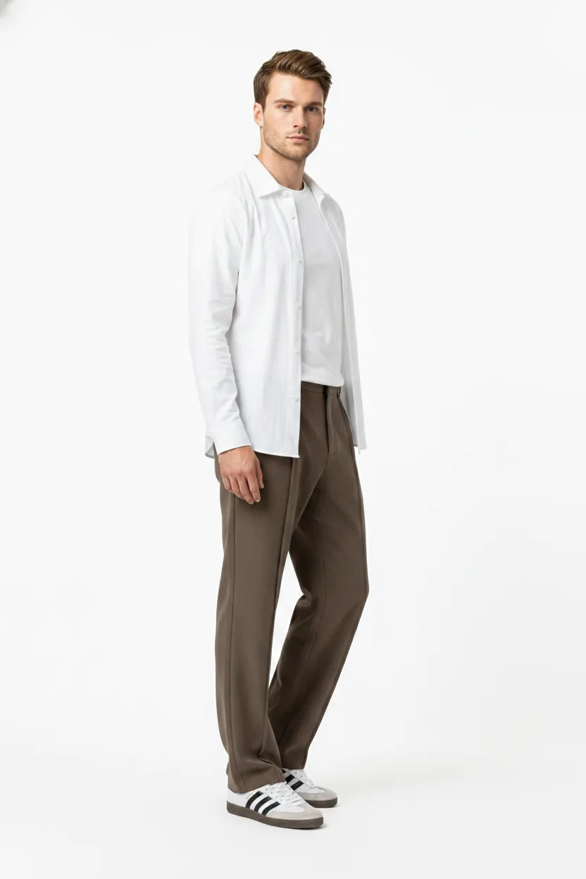 Brown pleated wide-leg trousers on a model in a three-quarter turn