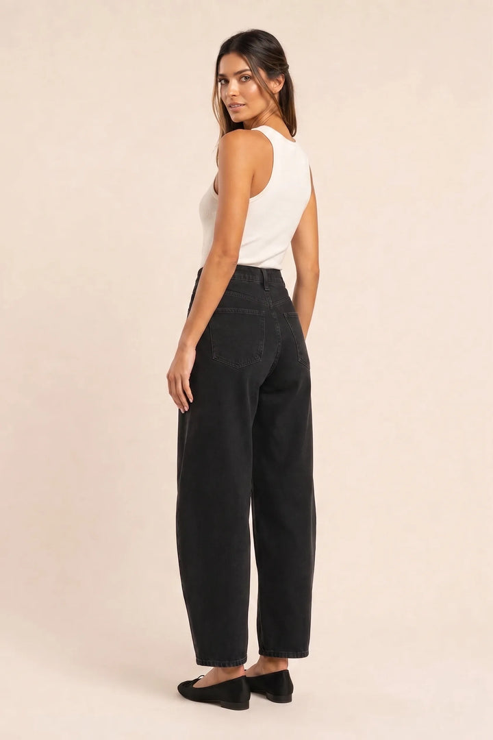Black barrel leg jeans on a model in a three-quarter turn