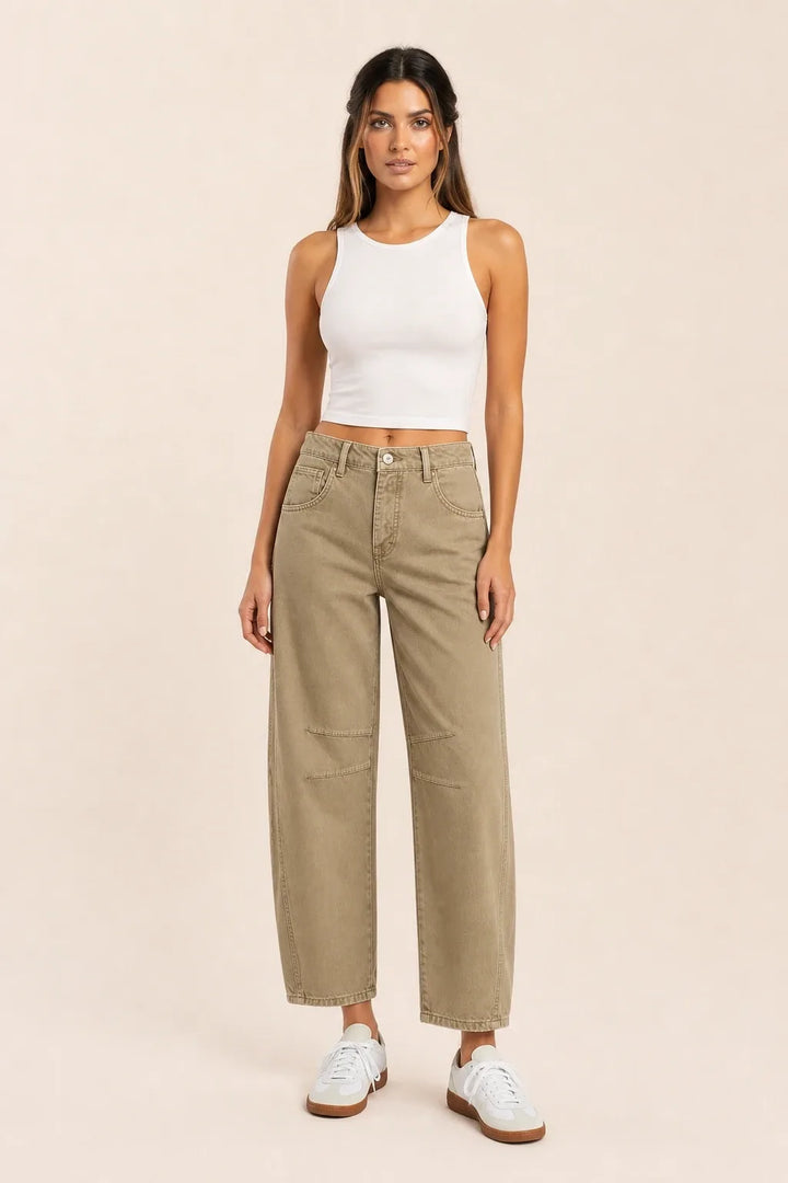 Khaki barrel leg jeans on a model standing in a contrapposto pose