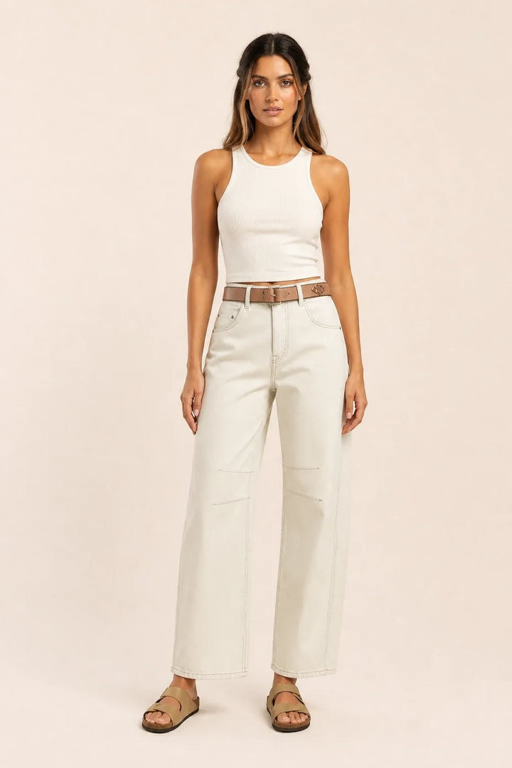 White barrel leg jeans on a model standing in a contrapposto pose