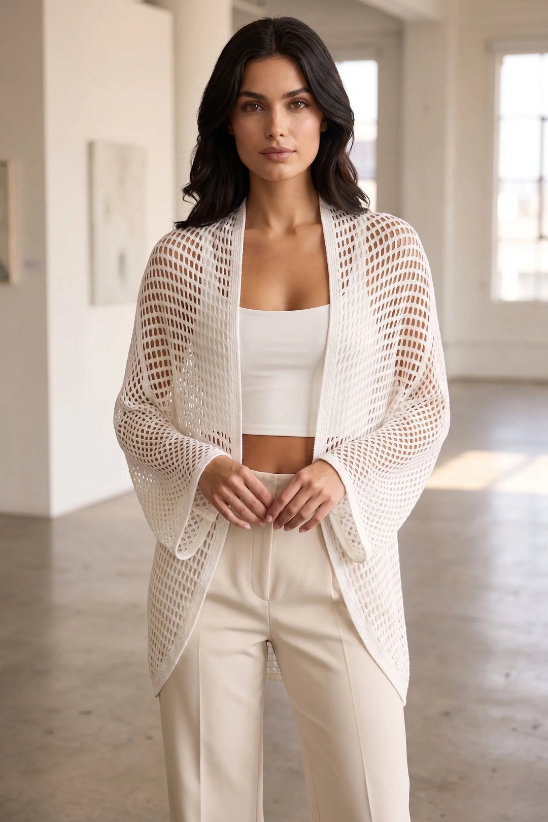 Model wearing white net knit open-weave cardigan in lifestyle setting