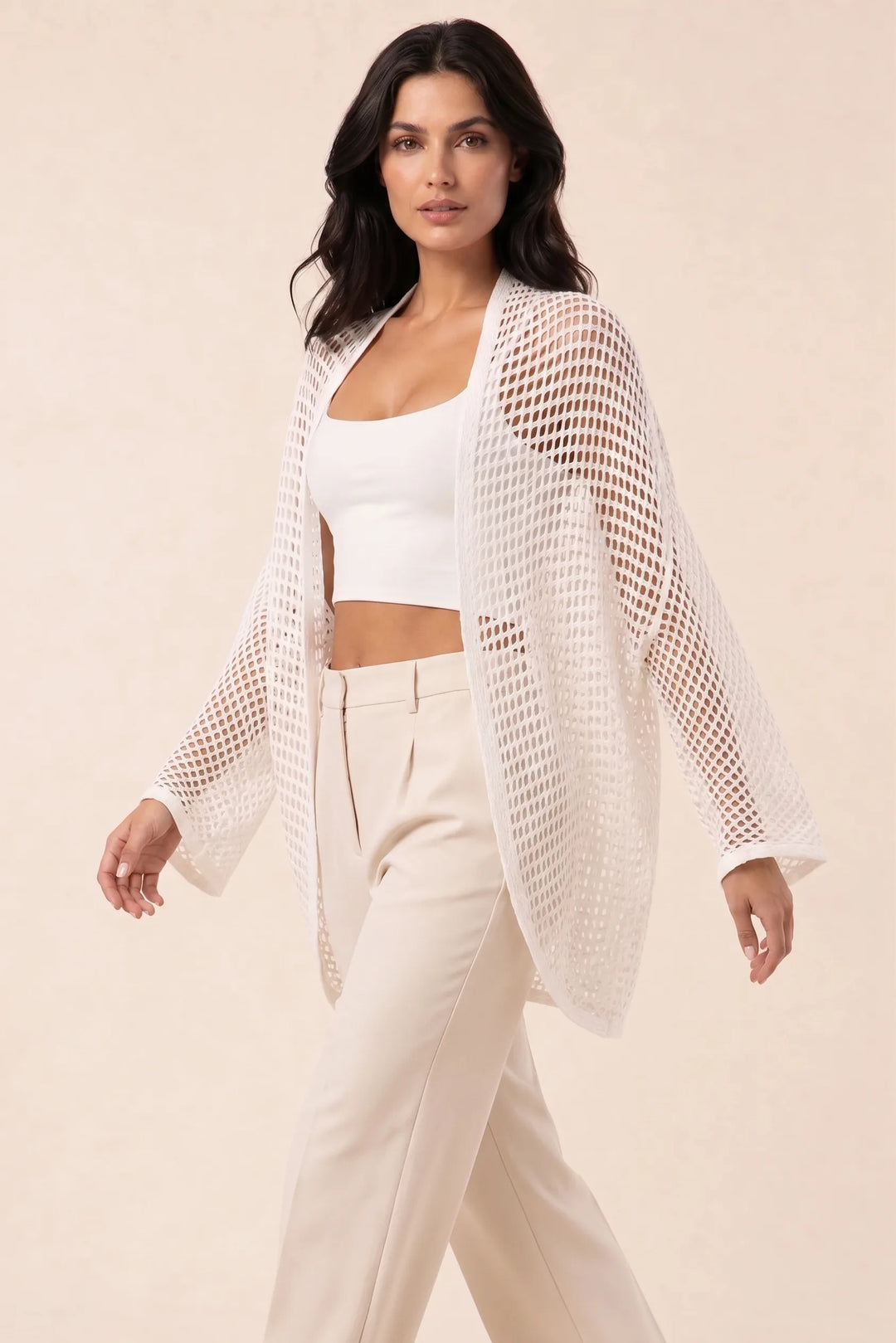 White net knit open-weave cardigan on model in three-quarter turn
