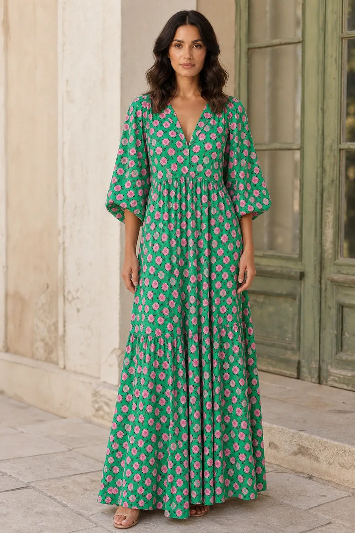 Green floral tiered maxi dress on model in contrapposto stance