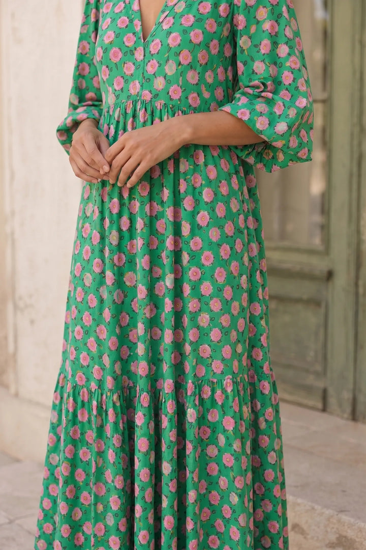 Close-up detail of green floral tiered maxi dress fabric and tiers