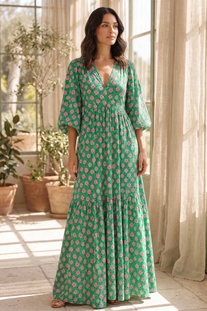 Model wearing green floral tiered maxi dress in outdoor lifestyle setting