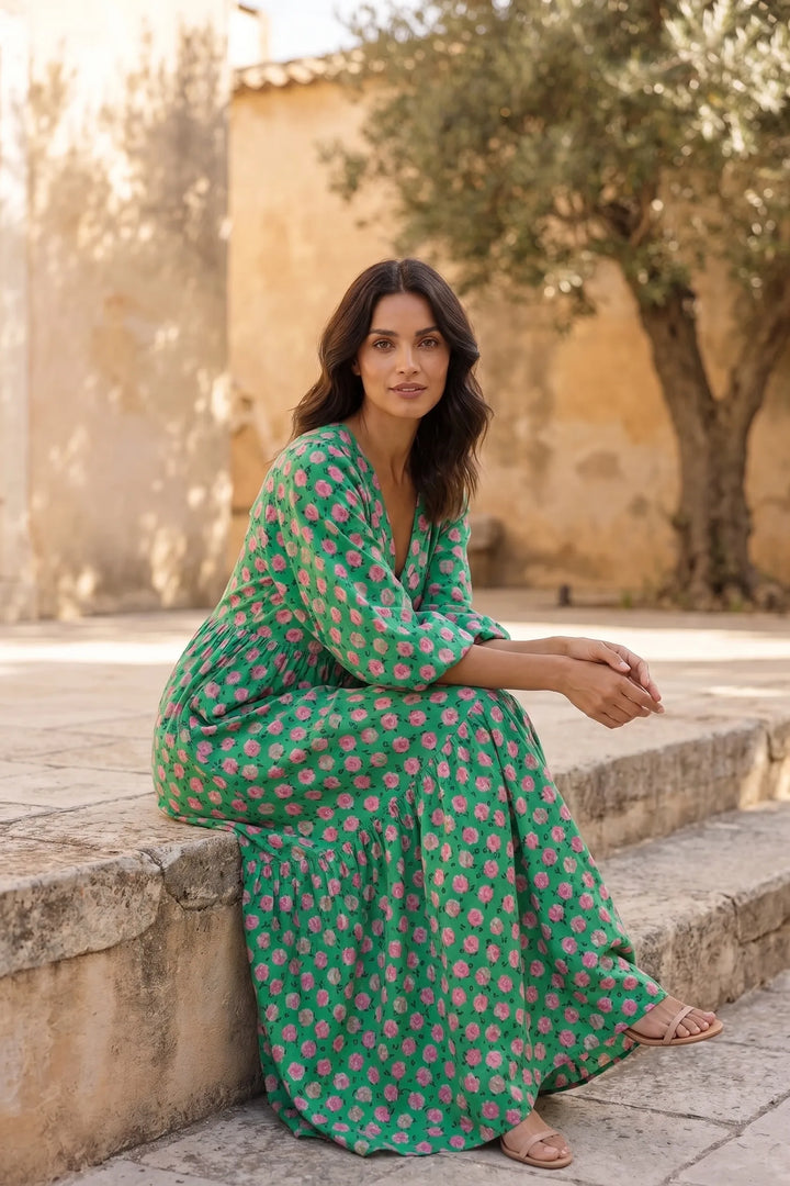 Model wearing green floral tiered maxi dress in second outdoor lifestyle scene