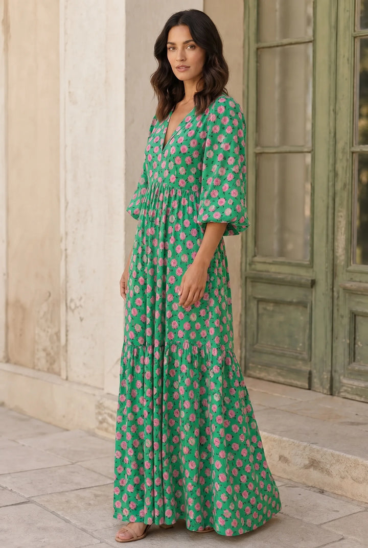 Green floral tiered maxi dress on model in three-quarter turn