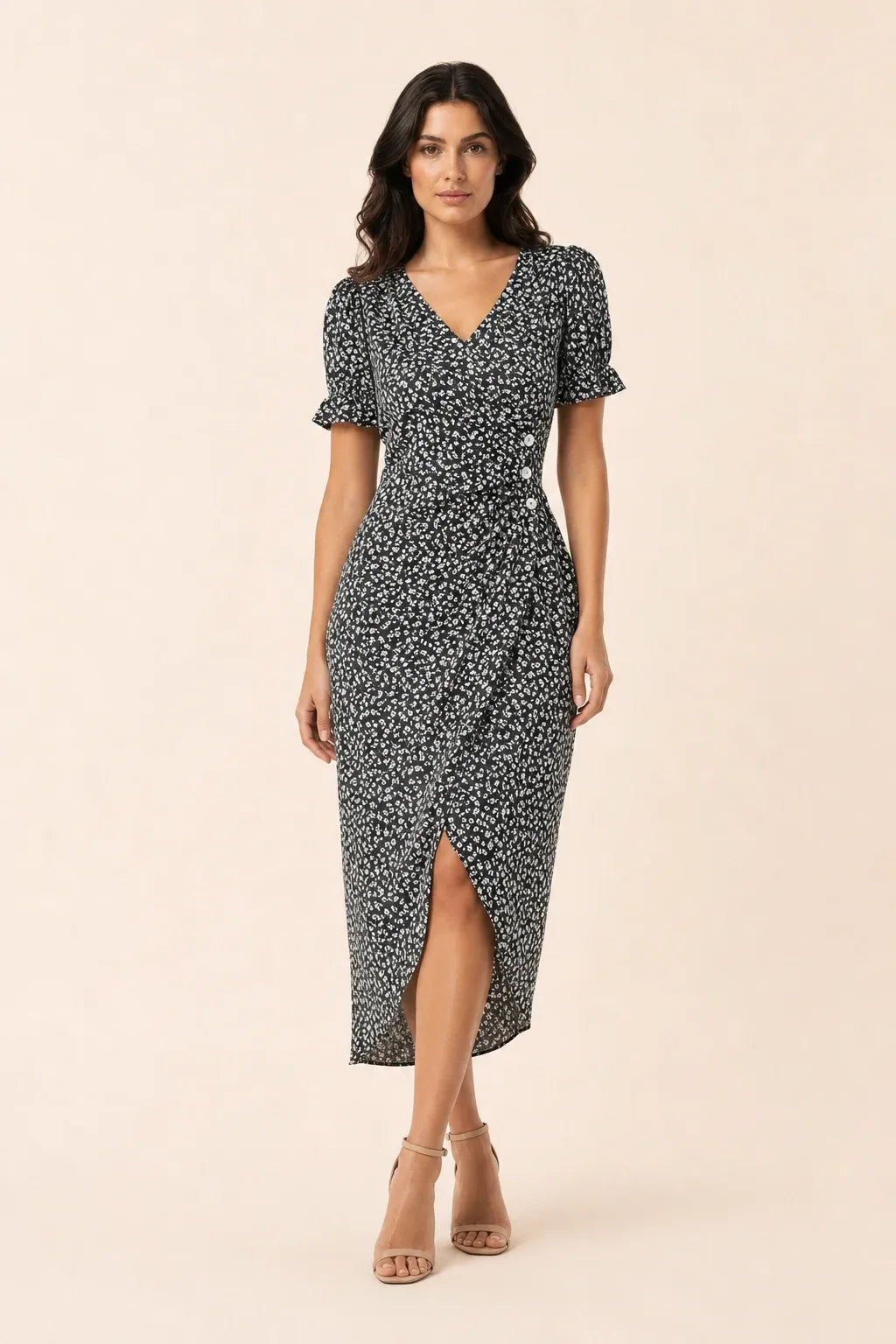 Black and white flutter sleeve wrap midi dress on model in contrapposto stance