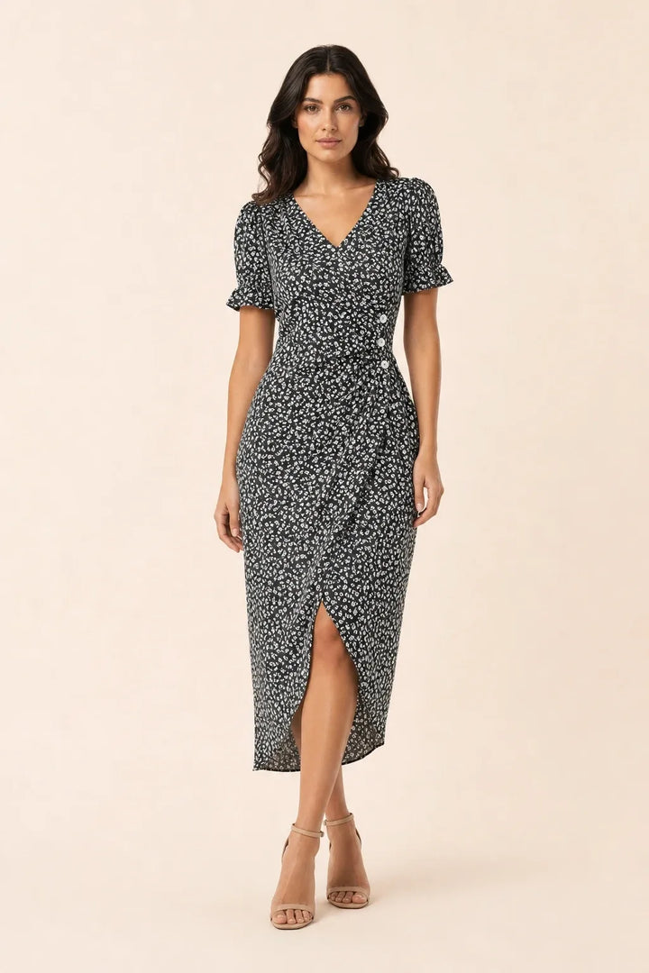 Black and white flutter sleeve wrap midi dress on model in contrapposto stance