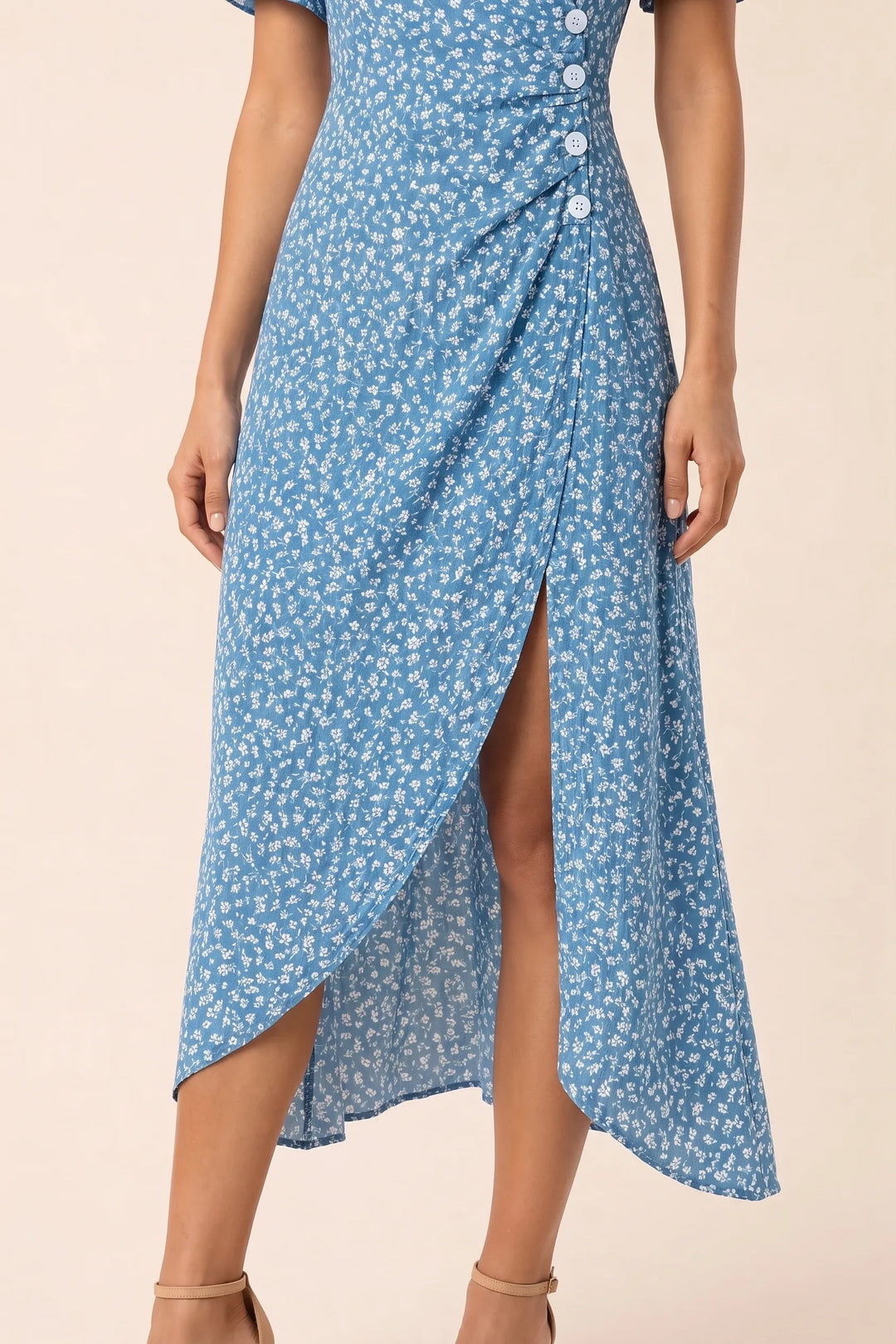 Close-up detail of blue flutter sleeve wrap midi dress fabric and construction