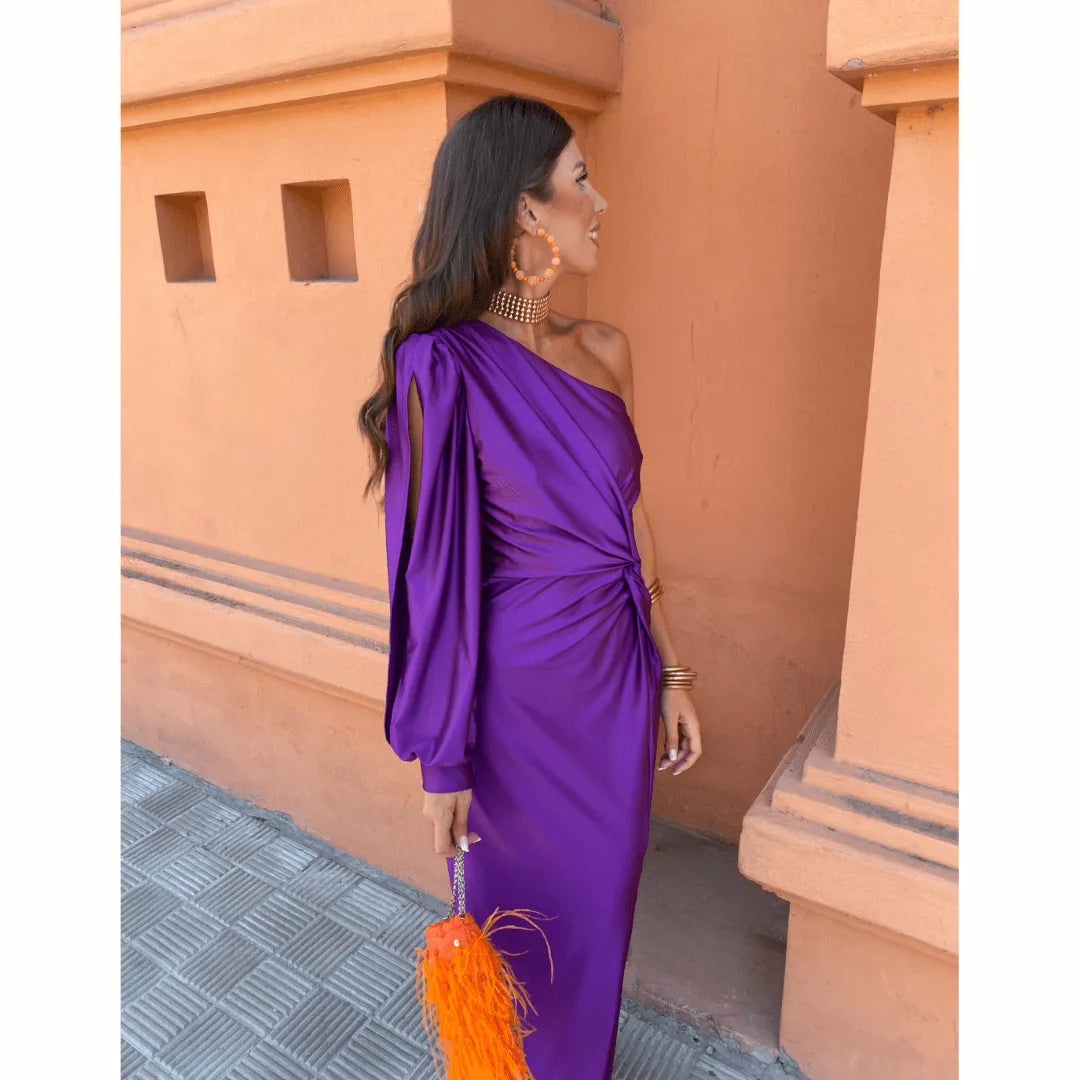 Woman posing in an olive green one-shoulder twist maxi dress, full-length view