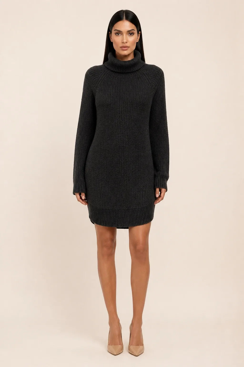 Black turtleneck sweater dress on a model in a contrapposto stance