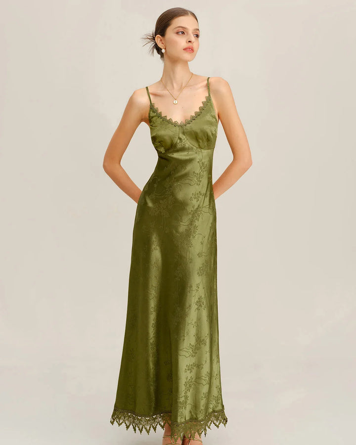 Model facing forward in a green jacquard maxi dress with lace-up front detailing