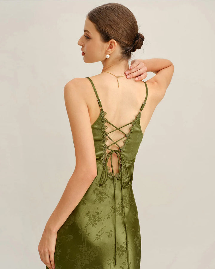 Side view of model wearing a green jacquard maxi dress with lace-up front
