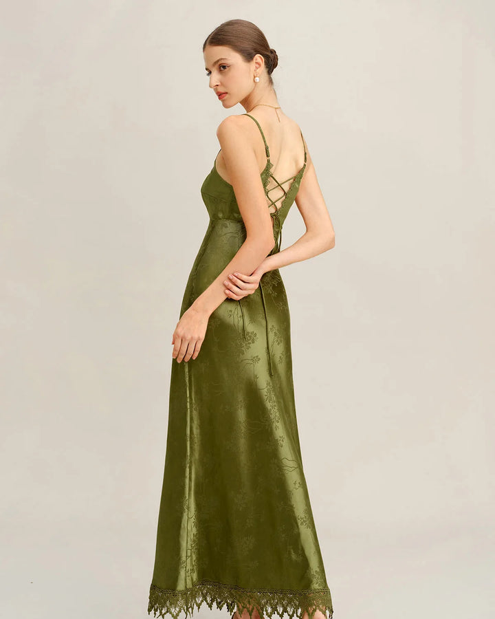 Model showcasing a green jacquard maxi dress with lace-up neckline detail