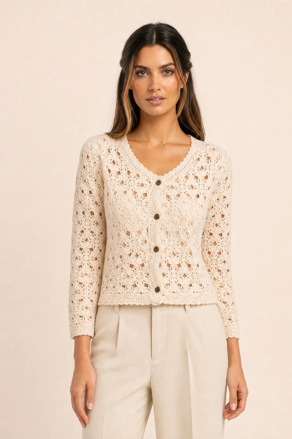 Apricot crochet scallop cardigan on model in contrapposto stance