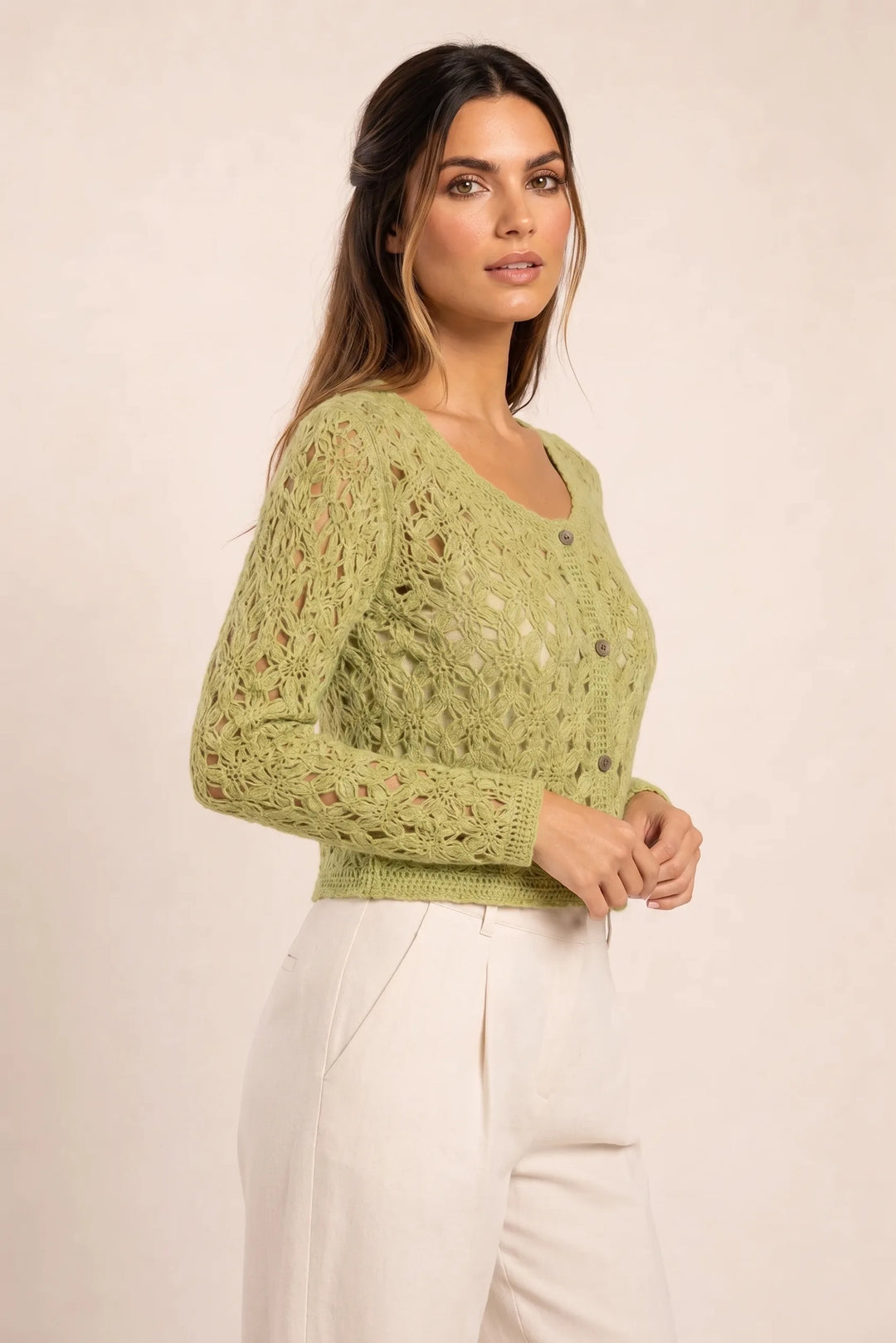 Green crochet scallop cardigan on model in three-quarter turn