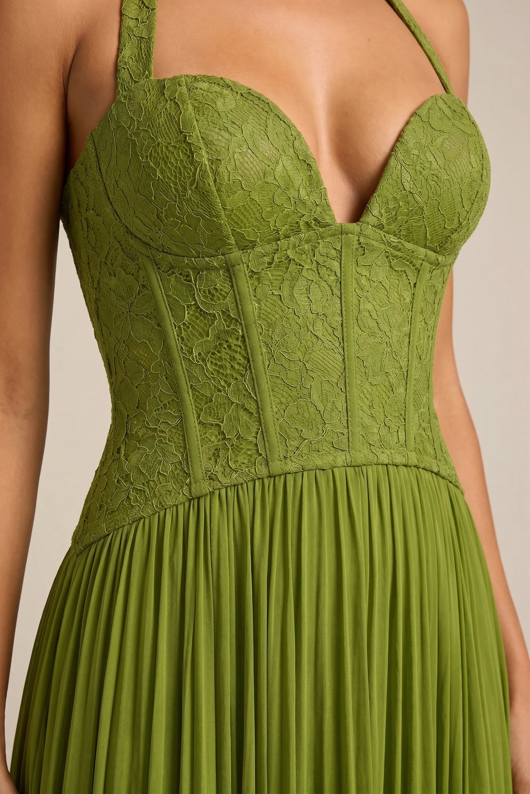 Close-up of green lace corset gown showing intricate lace texture and boned bodice construction