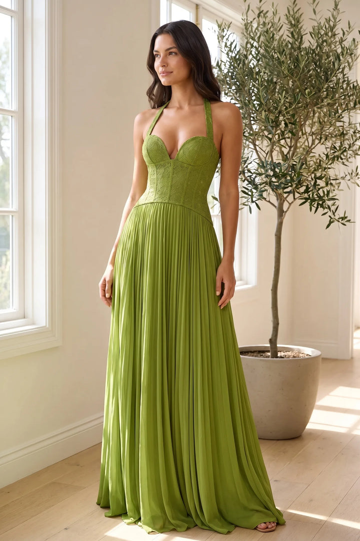Model wearing a green lace corset gown in a styled lifestyle setting
