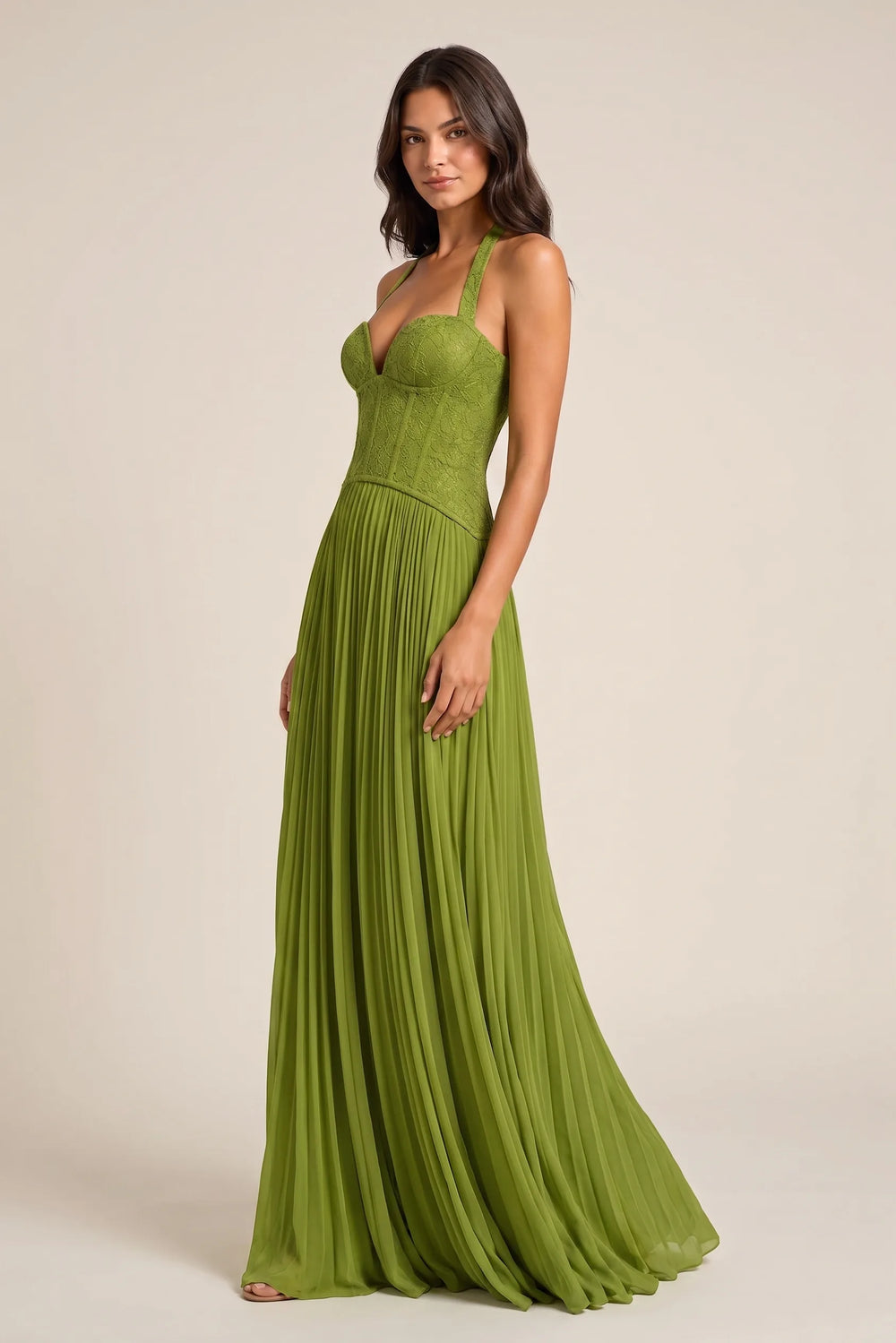 Model in three-quarter turn showing the back detail of a green lace corset gown