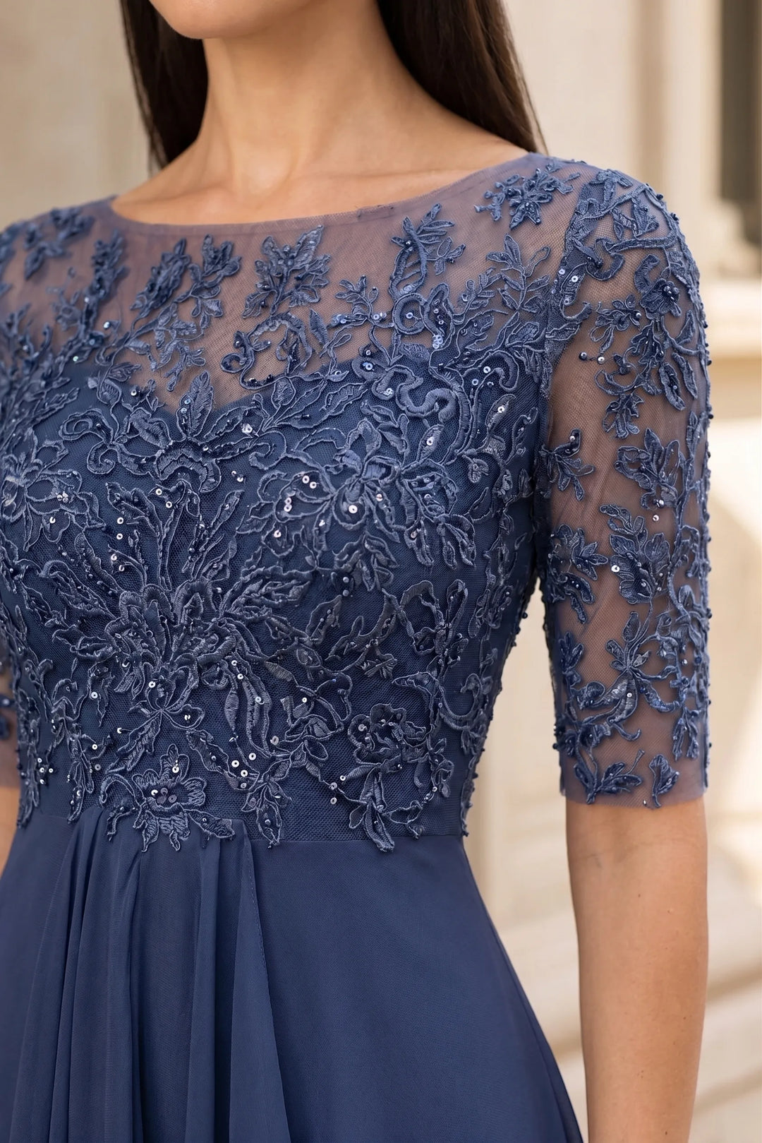 Close-up detail of blue lace illusion midi dress fabric and construction