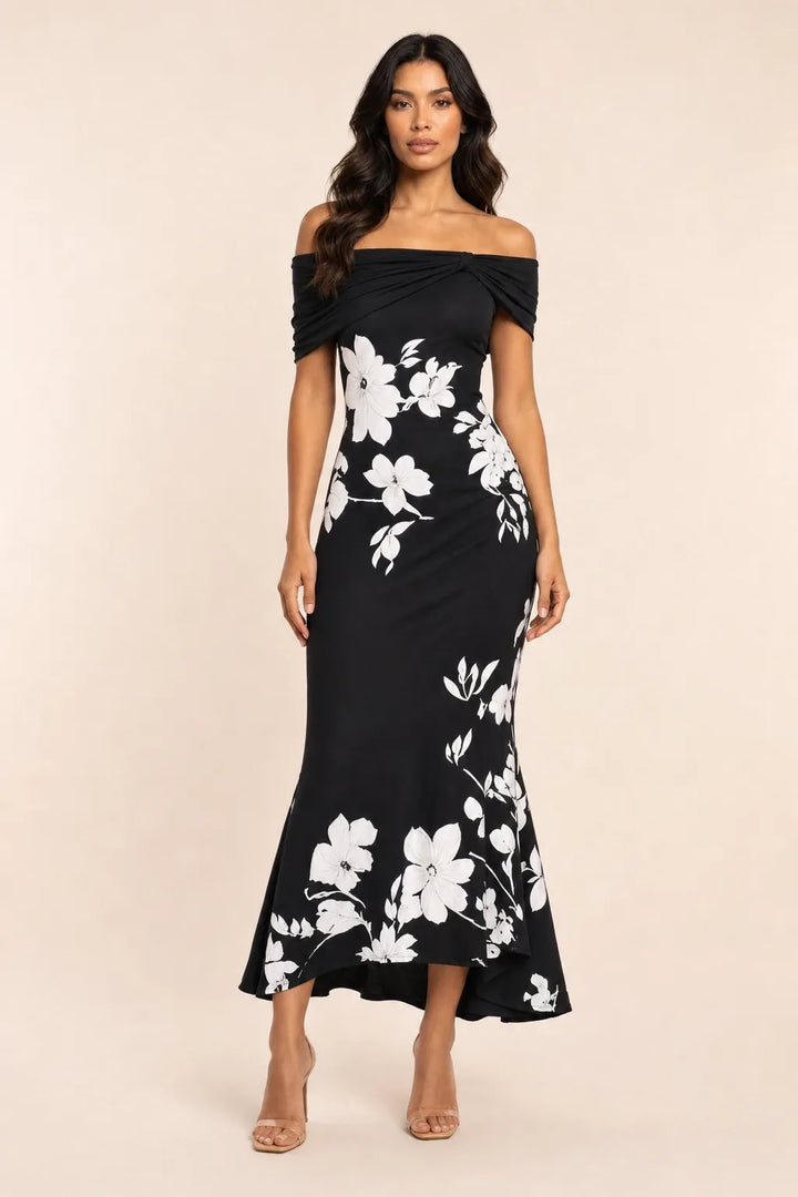 Black twist knot mermaid midi dress on model in contrapposto stance