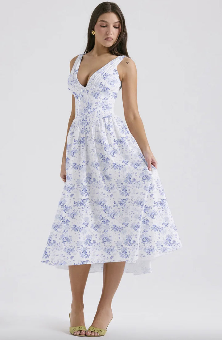 Model in profile view wearing a blue floral corset midi dress with fitted waist