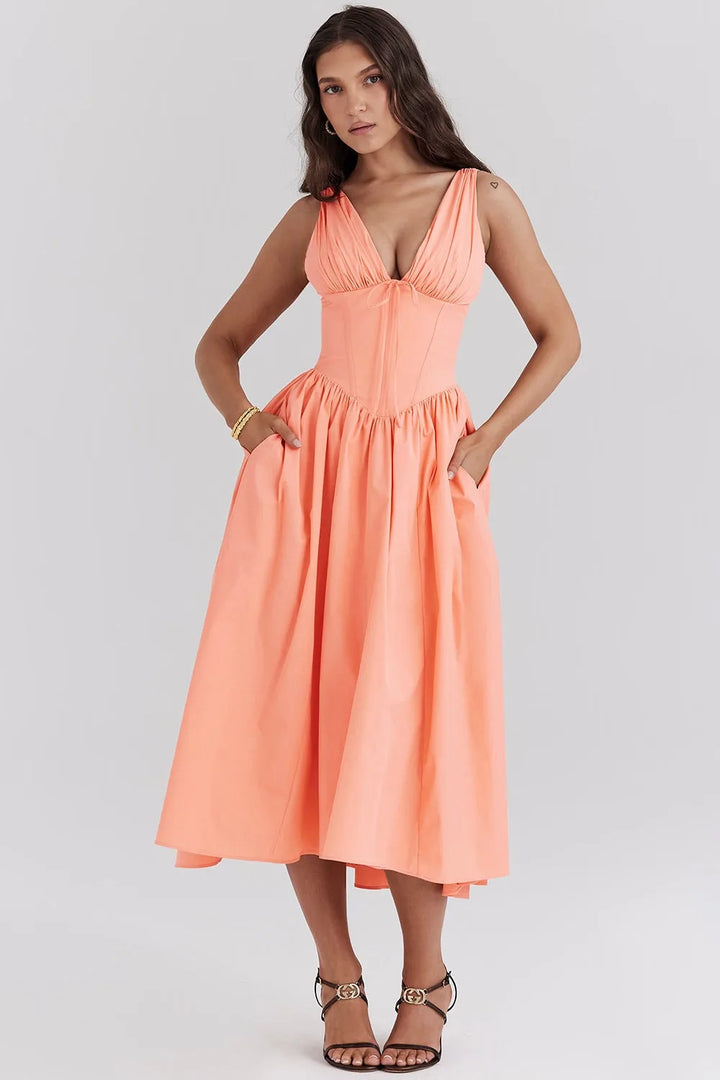 Close-up detail of a peach floral corset midi dress showing boning and fabric texture