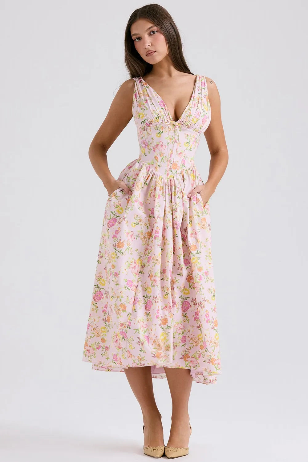 Model in a three-quarter turn wearing a pink floral corset midi dress with boned bodice