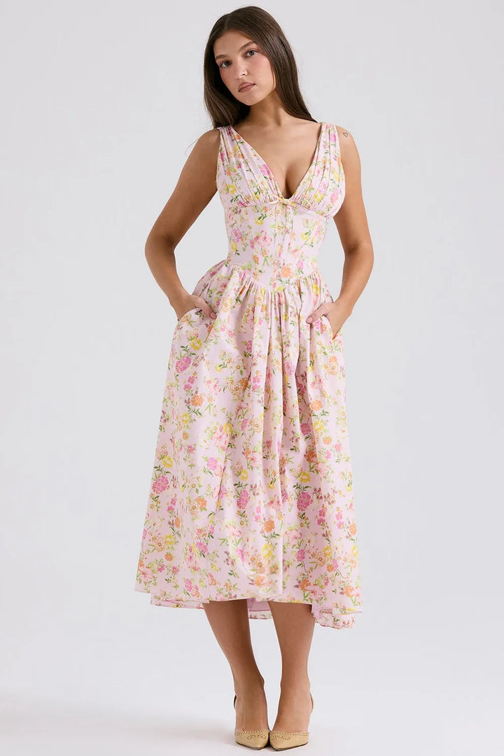 Model in a three-quarter turn wearing a pink floral corset midi dress with boned bodice