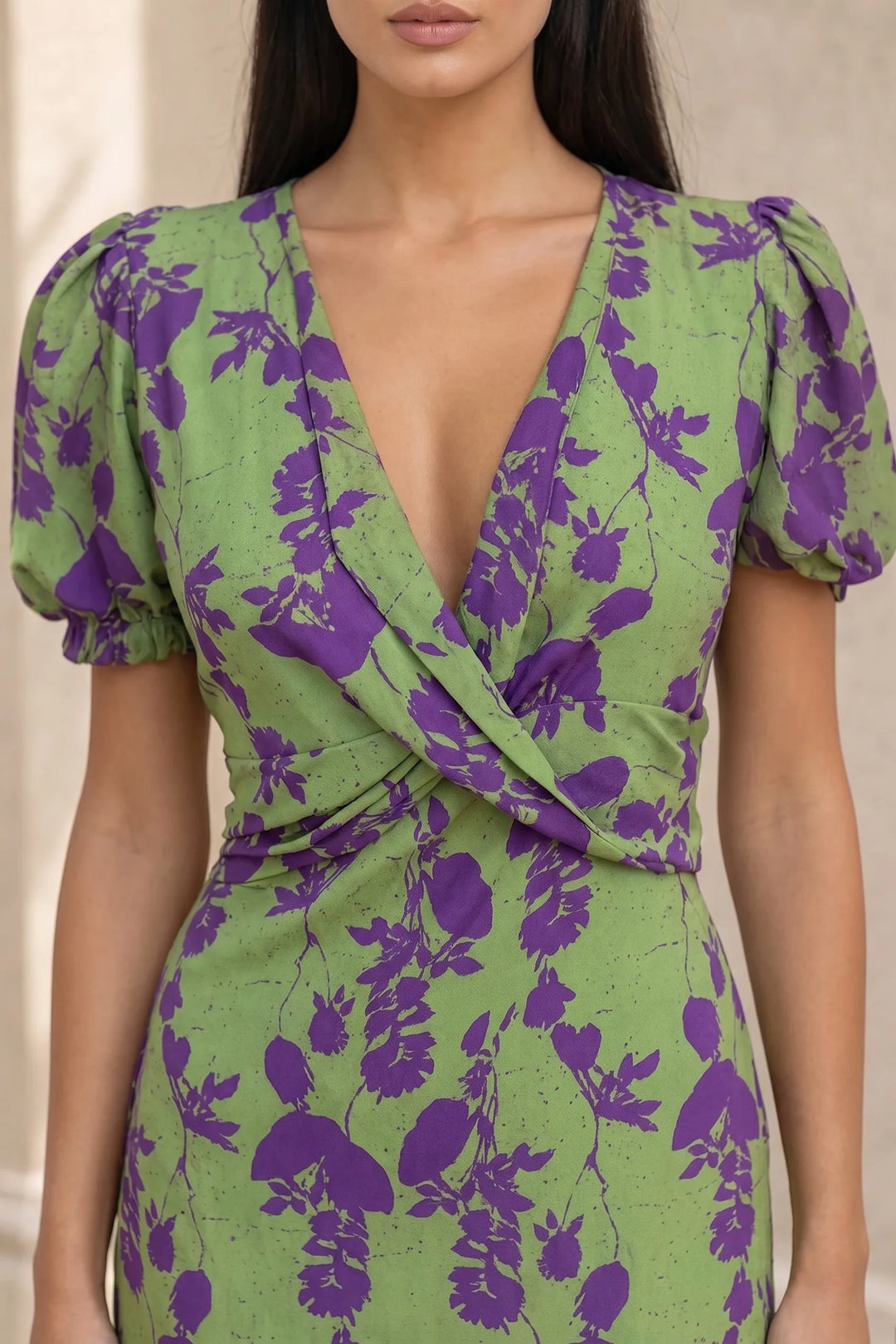 Close-up detail of green floral wrap midi dress fabric and wrap tie