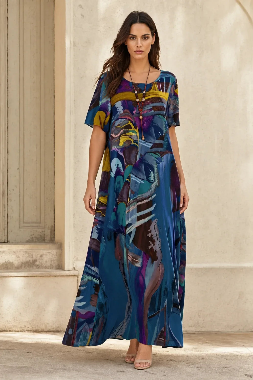 Blue abstract-print midi dress on model standing in contrapposto pose