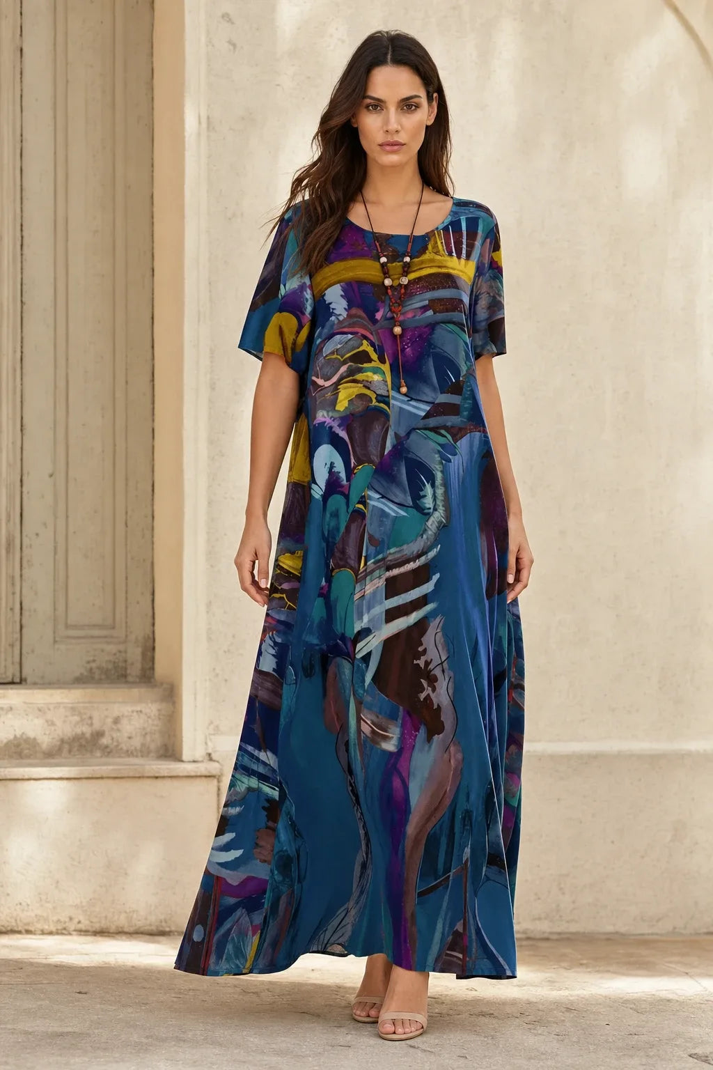 Blue abstract-print midi dress on model standing in contrapposto pose