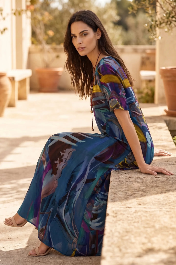 Model wearing blue abstract-print midi dress in outdoor lifestyle setting
